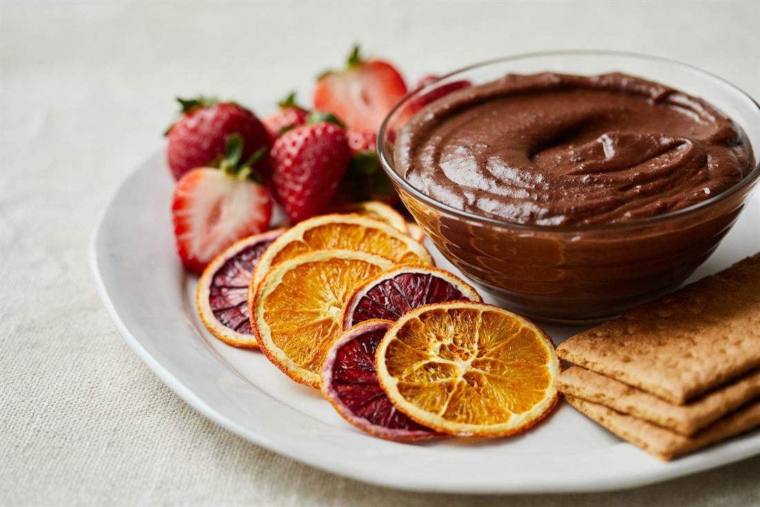 Dark chocolate dessert with strawberries and dried blood orange slices
