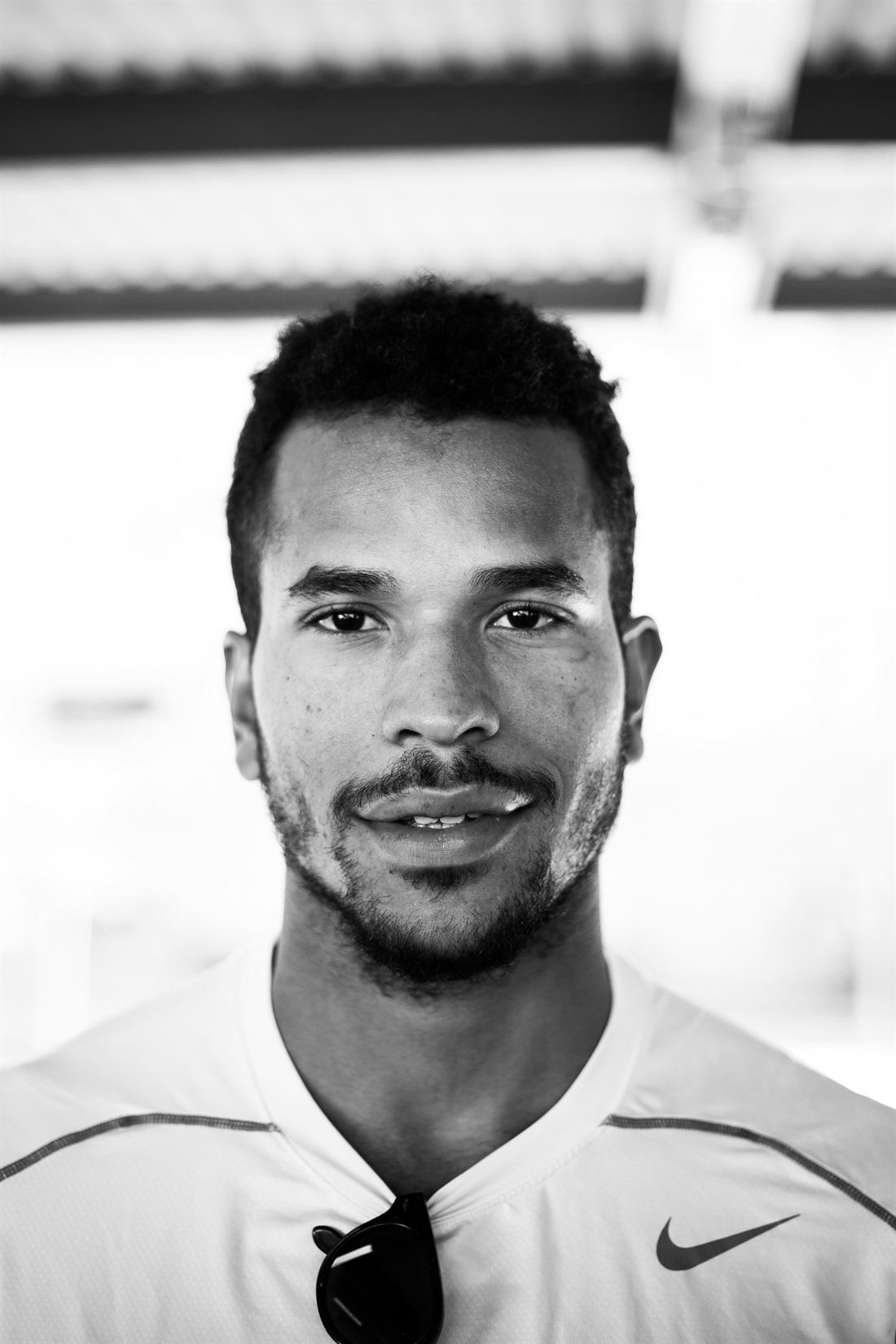 Black and white portrait of Thabo Mokoena, performance coach, looking straight at the camera