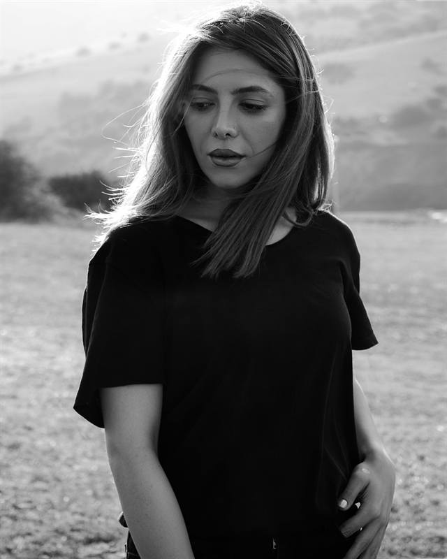 Black and white portrait of a woman in a field