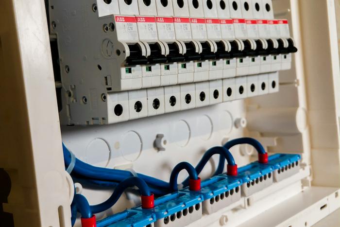 A new distribution board with a row of circuit breakers and neatly dressed wiring